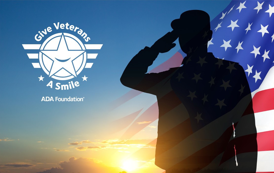An image of a veteran saluting with the American flag and sunset